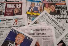 Newspaper headlines about Trump indictment and charges.