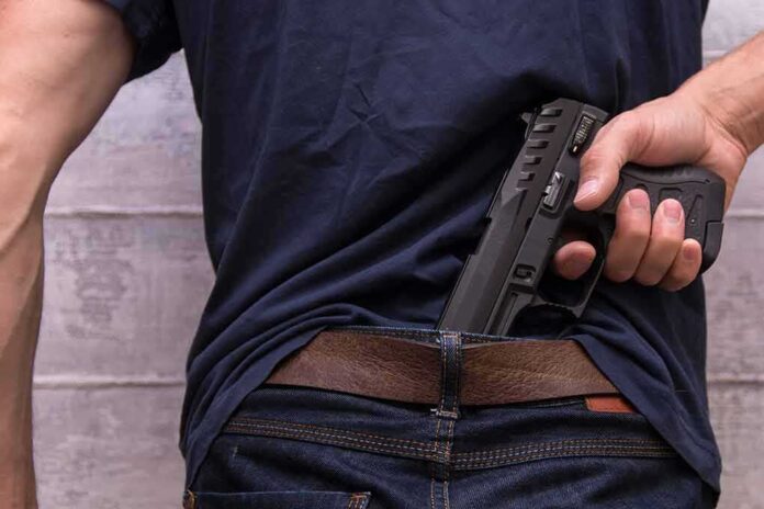 1493432837 featured image Person concealing a handgun in waistband.
