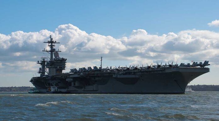 1347055766 featured image Aircraft carrier on water under a cloudy sky.