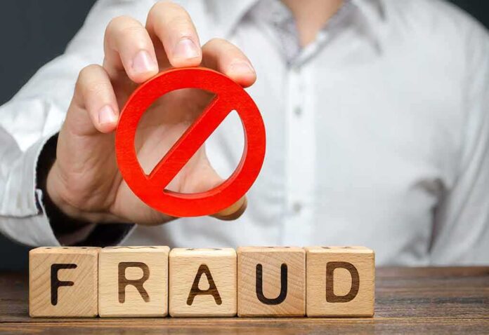 1488438023 featured image Blocks spelling fraud with hand holding red prohibition sign