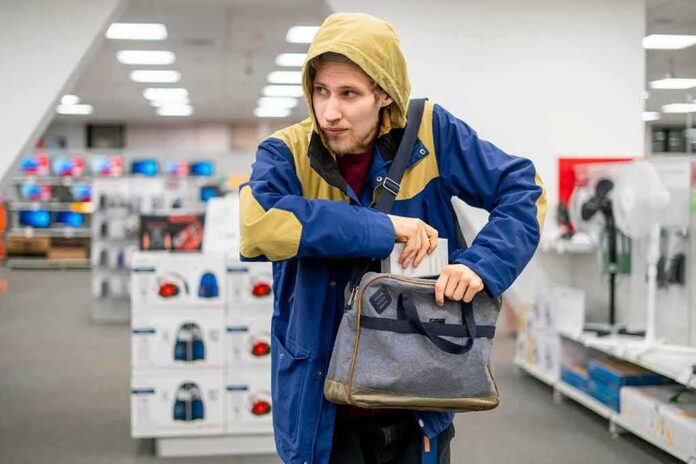 1217013973 featured image Person in store, hiding something in a bag.
