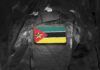 Mozambican flag patch on camouflage uniform sleeve.