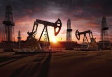 Oil rigs operating at sunset in a desert landscape