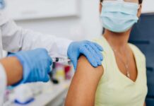 Woman receiving a shot in the arm