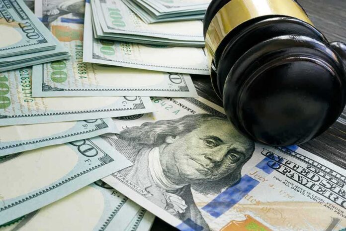 2006624330 featured image Gavel and hundred dollar bills on table.