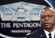 Man speaking in front of Pentagon sign