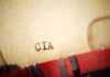 Typewriter typing paper with CIA letters visible