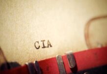 Typewriter typing paper with CIA letters visible