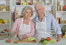 Elderly couple cooking together in the kitchen