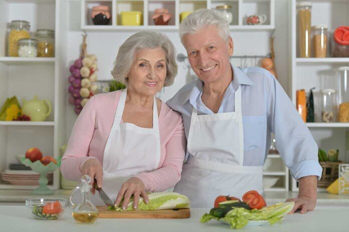 455024224 featured image Elderly couple cooking together in the kitchen