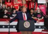 Person speaking at podium with crowd behind them
