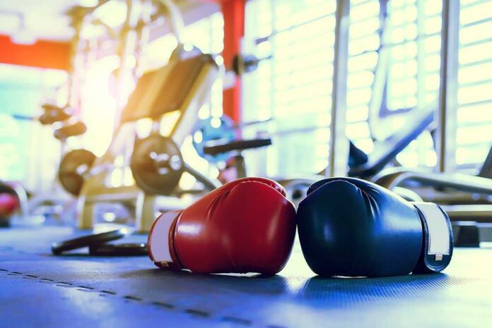 392673820 featured image Boxing gloves on gym floor with equipment