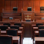 Empty courtroom with wooden benches and judge's bench