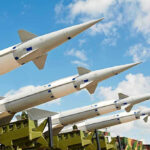 Missile Armageddon: Russia Launching 1,000 PER DAY Multiple missiles pointed upward on launchers against blue sky
