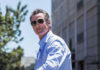 Man in sunglasses wearing a blue button up shirt