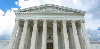 Building with columns under a cloudy sky