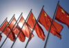 Red flags with yellow stars on flagpoles.