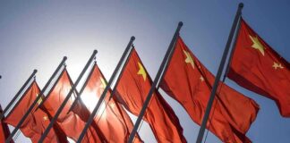 Red flags with yellow stars on flagpoles.