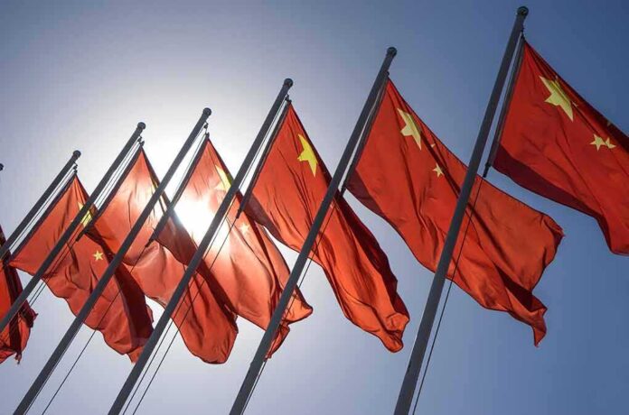 325058183 featured image Red flags with yellow stars on flagpoles.