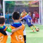 Two boys watching a soccer game together