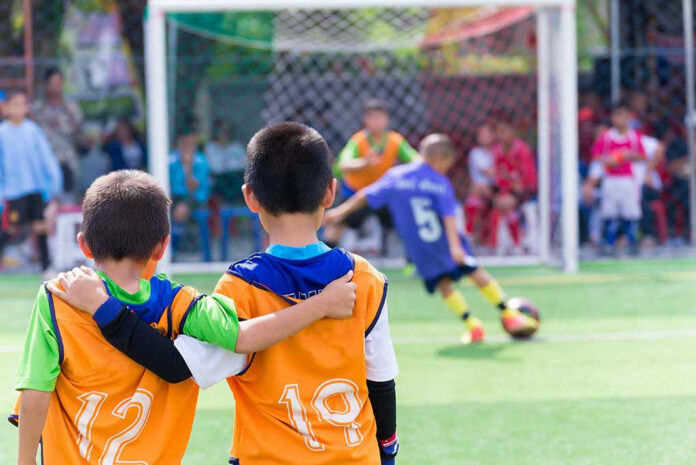 Two boys watching a soccer game together