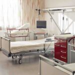 A hospital room featuring empty patient beds and medical equipment