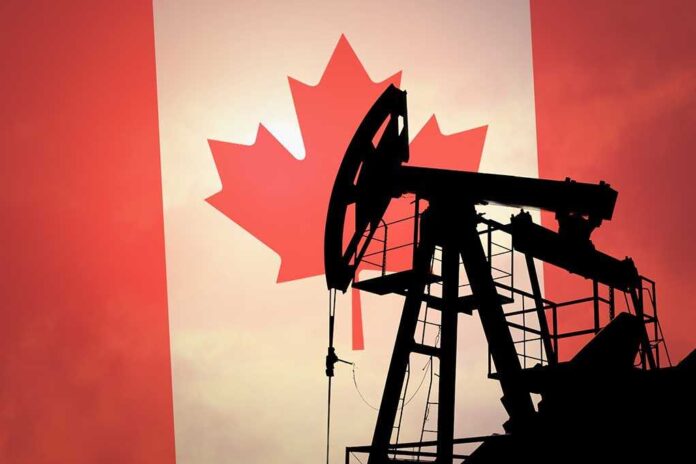 Silhouette of an oil rig against the Canadian flag