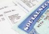 Close up of a pay stub and a social security card