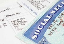 Close up of a pay stub and a social security card