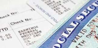 Close up of a pay stub and a social security card