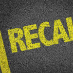 Ford’s SHOCKING Recall – Hidden Risk Revealed! Yellow RECALL text on asphalt background.