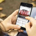 Federal Probe STUNS — FAKE Crime Stats Accusation Person holding smartphone displaying fake news notification.