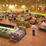 CDC Reveals SHOCKING Food Crisis in America Interior of a grocery store filled with fresh produce and shoppers