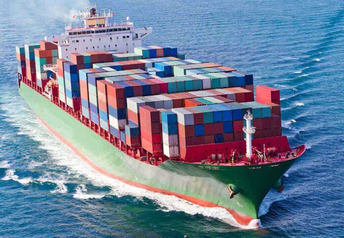 A large cargo ship loaded with colorful containers sailing on the ocean