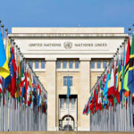 Israel SLAMS UN Report—Calls It Antisemitic United Nations building with numerous national flags outside.