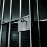Shocking Legal Twist: Beating Case Dismissed Close up of a locked prison gate with metal bars