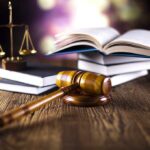 Predators Infiltrate Roblox — Children in Danger! A gavel, legal books, and scales of justice on a wooden table
