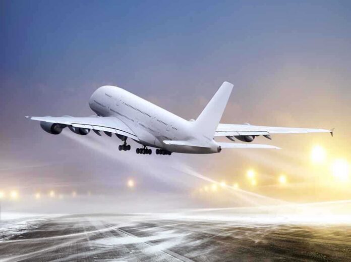 An airplane taking off from an airport runway against a twilight sky