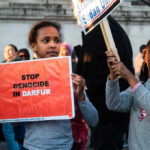 Children holding signs at a protest against Darfur genocide