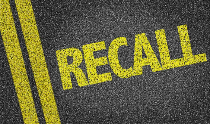 Yellow RECALL text on asphalt background