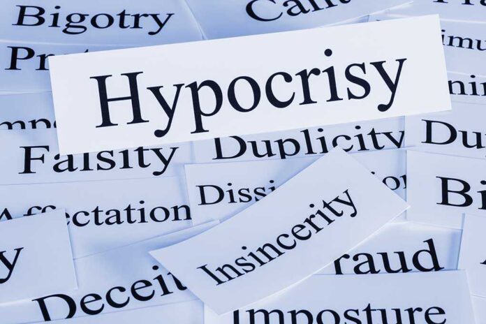 A collection of paper cards with various negative terms prominently featuring the word Hypocrisy