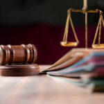 Judges gavel, scales of justice, and legal documents.