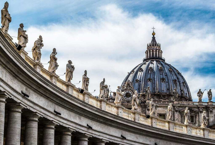 St Peters Basilica dome with statues and clouds