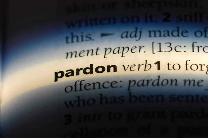 1155434380 The word pardon highlighted in a dictionary.
