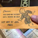 DEPORTED Killer FREED by DA — Man Dead Monopoly game card get out of jail free