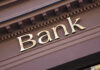 Bank sign on building facade.
