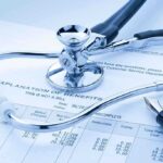 2026 Insurance BOMBSHELL: 22 Million at RISK A stethoscope resting on a medical billing statement