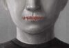 A human figure with stitched lips, symbolizing silence or repression