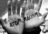 Two hands with Stop Racism written on them.