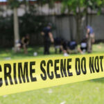 UPDATE: Crime Scene Found — Today Host’s Mother VANISHES Yellow crime scene tape blocking grassy area.